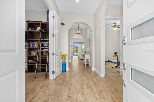 entryway with ceiling fan and light wood-type flooring