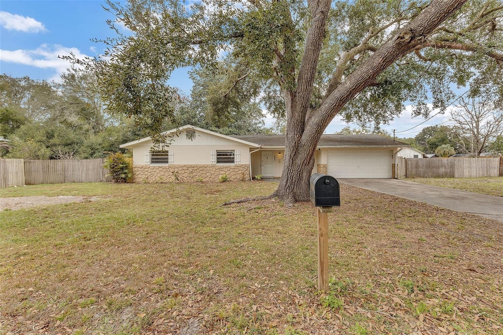 single story home featuring a garage and a front lawn