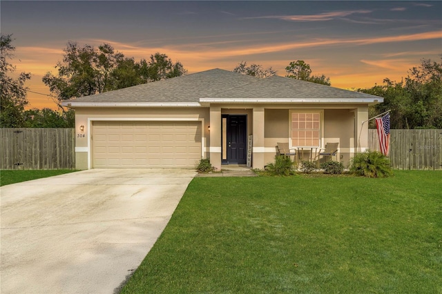 view of front of house with a porch, a garage, and a lawn