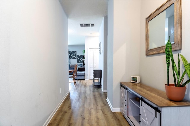 corridor with light hardwood / wood-style flooring