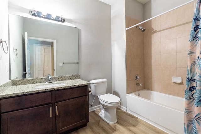 full bathroom featuring hardwood / wood-style flooring, toilet, shower / tub combo, and vanity