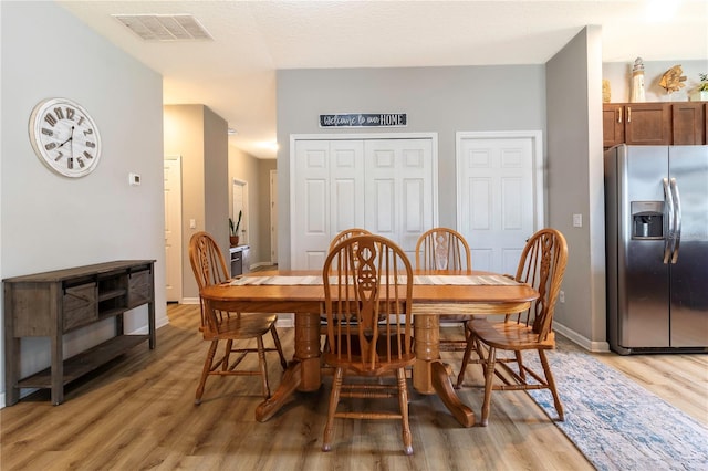 dining space featuring light hardwood / wood-style flooring