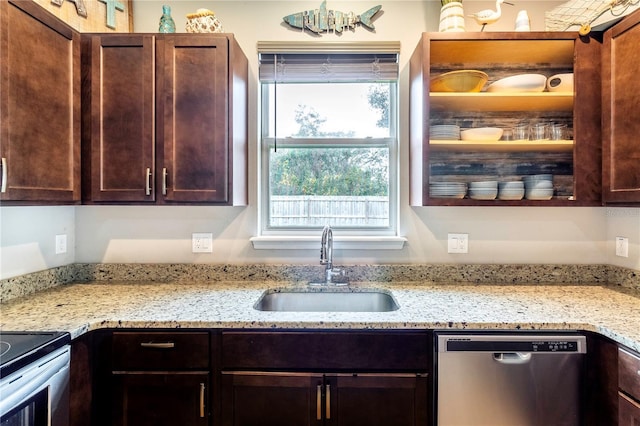 kitchen with sink, light stone countertops, and appliances with stainless steel finishes