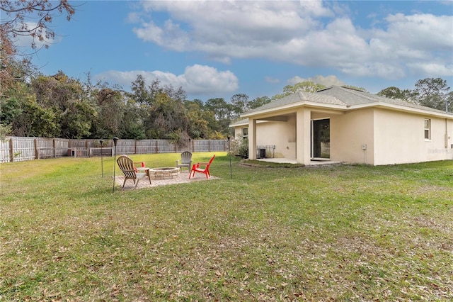 view of yard with a fire pit and a patio area