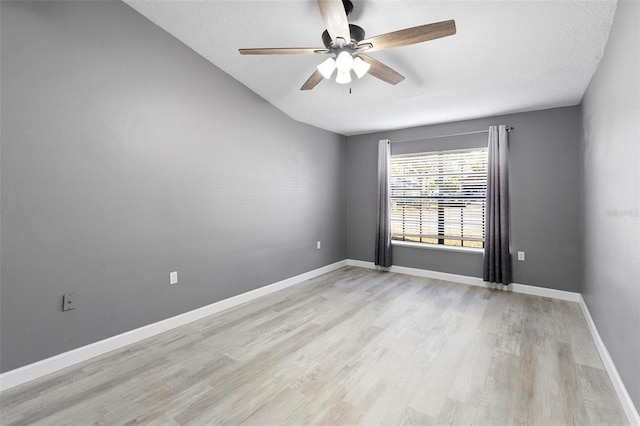 unfurnished room with ceiling fan, light hardwood / wood-style flooring, and a textured ceiling