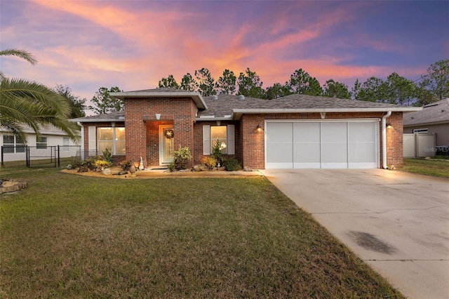 view of front of home featuring a garage and a lawn