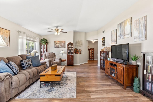 living room with light hardwood / wood-style floors and ceiling fan