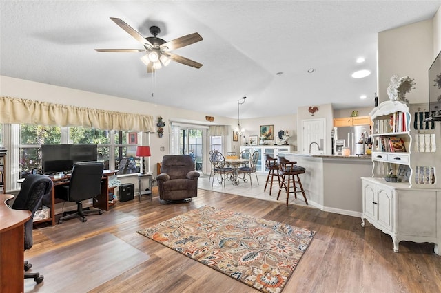 office featuring hardwood / wood-style floors, a textured ceiling, vaulted ceiling, and ceiling fan