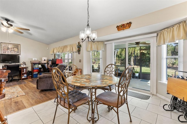 dining area with vaulted ceiling, light tile patterned floors, and ceiling fan