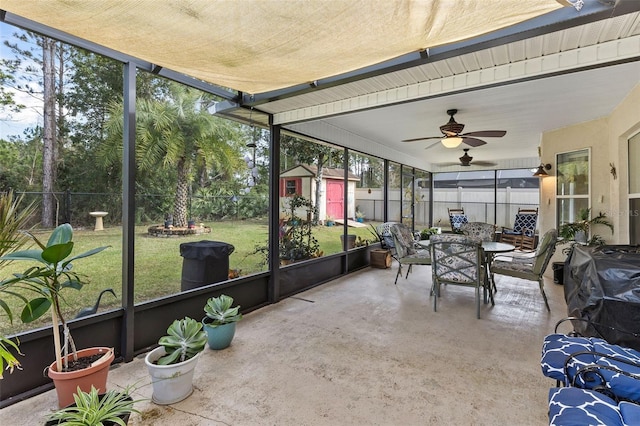 sunroom / solarium featuring ceiling fan