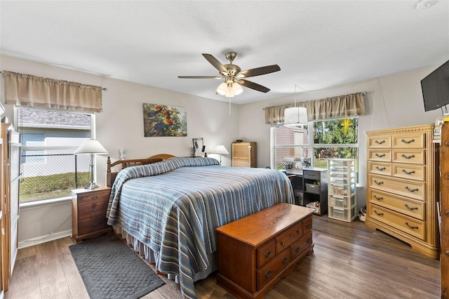 bedroom featuring ceiling fan and dark hardwood / wood-style floors