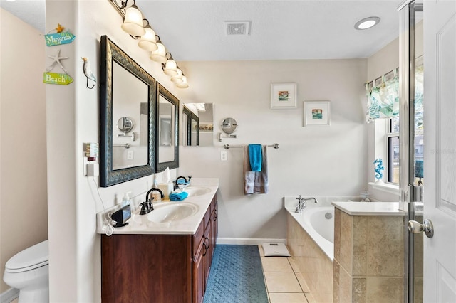 bathroom with tile patterned floors, a textured ceiling, toilet, a relaxing tiled tub, and vanity