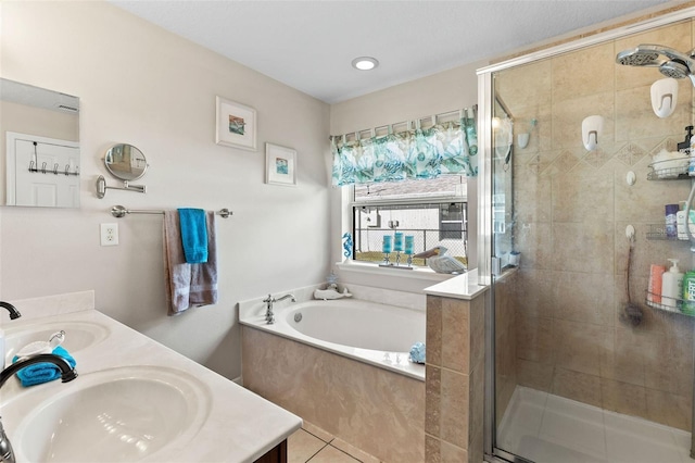 bathroom with tile patterned floors, vanity, and separate shower and tub