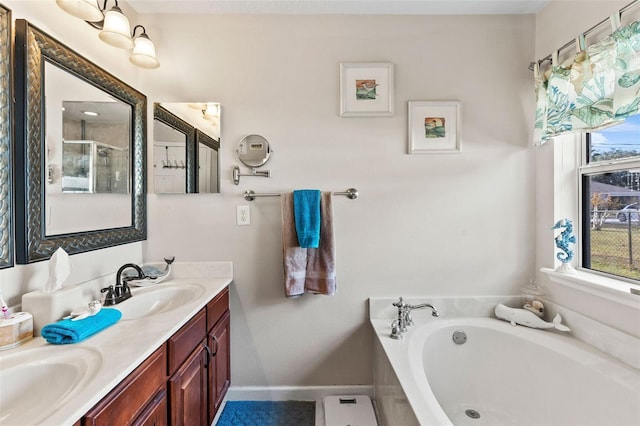 bathroom with a tub and vanity