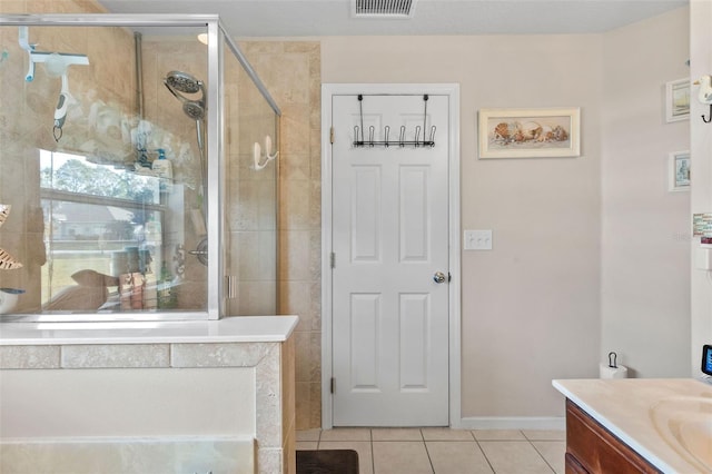 bathroom featuring vanity, walk in shower, and tile patterned floors