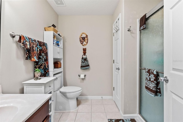 bathroom with an enclosed shower, tile patterned floors, a textured ceiling, toilet, and vanity