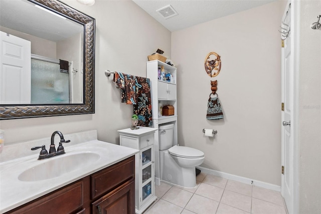 bathroom featuring toilet, tile patterned floors, and vanity