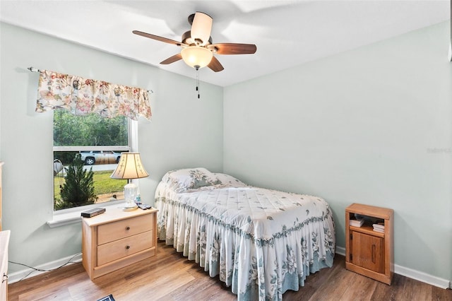 bedroom with hardwood / wood-style floors and ceiling fan