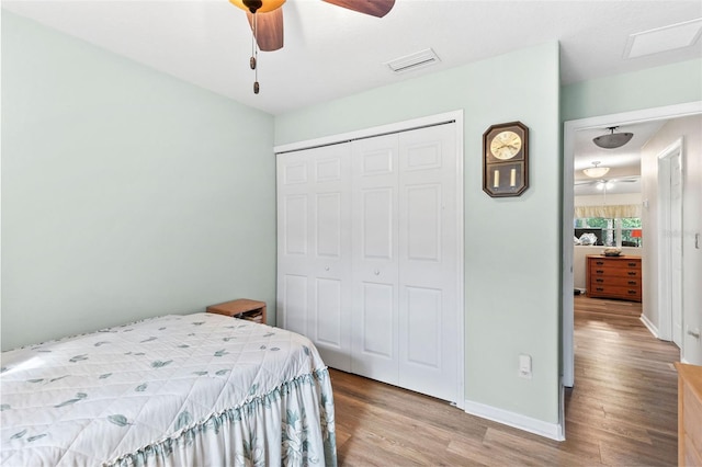 bedroom with light hardwood / wood-style floors, a closet, and ceiling fan