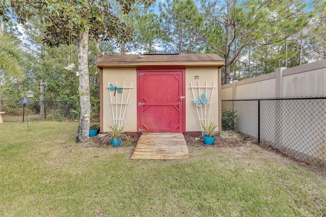 view of outbuilding with a yard