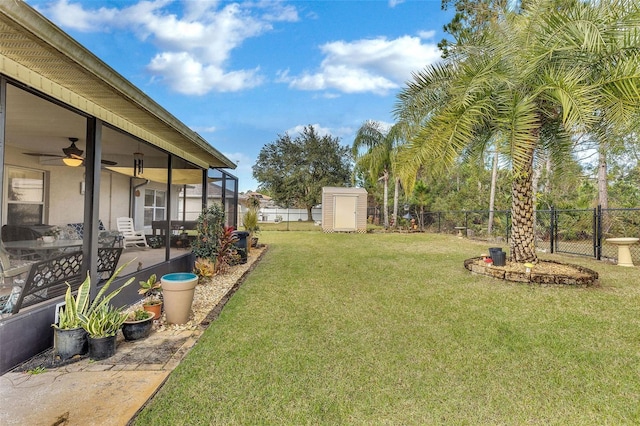 view of yard with ceiling fan and a storage shed