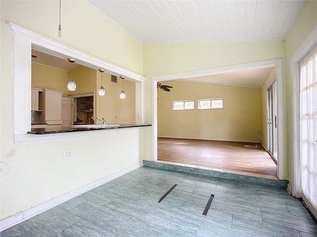 unfurnished room with lofted ceiling, sink, wooden ceiling, and ceiling fan