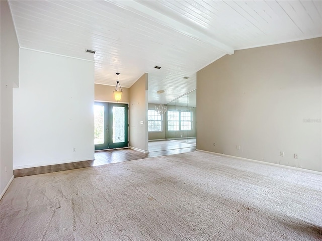 unfurnished living room featuring french doors, wood ceiling, carpet, and vaulted ceiling with beams