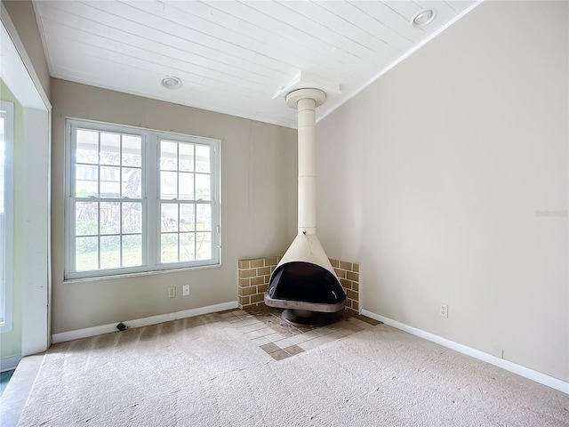 room details featuring wood ceiling, carpet, and a wood stove