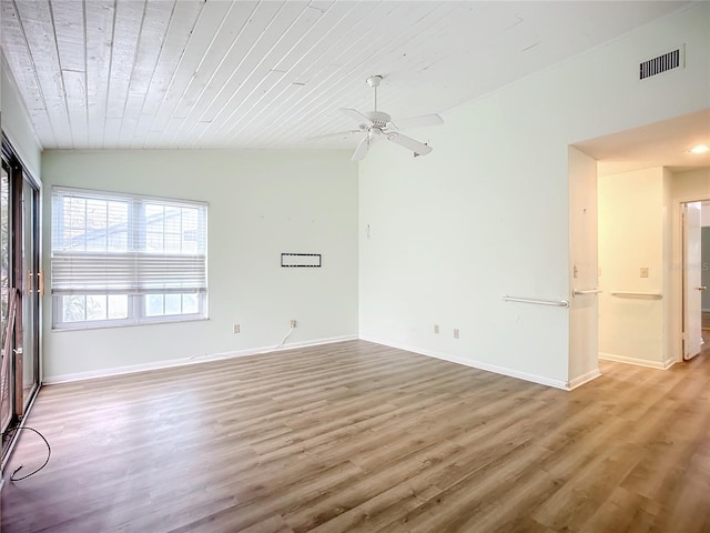 unfurnished room with hardwood / wood-style flooring, vaulted ceiling, wooden ceiling, and ceiling fan