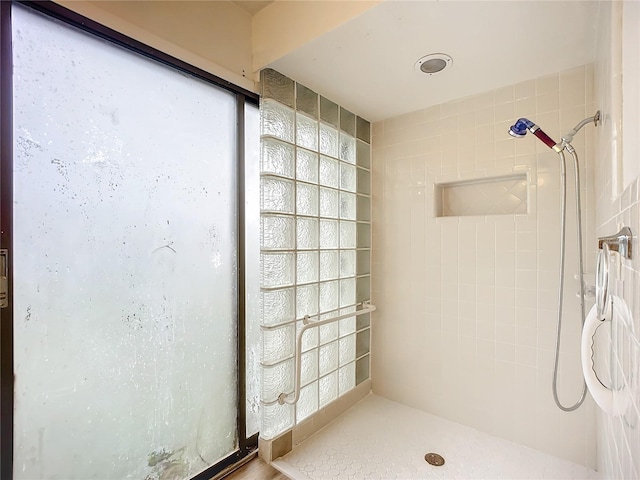 bathroom with tiled shower