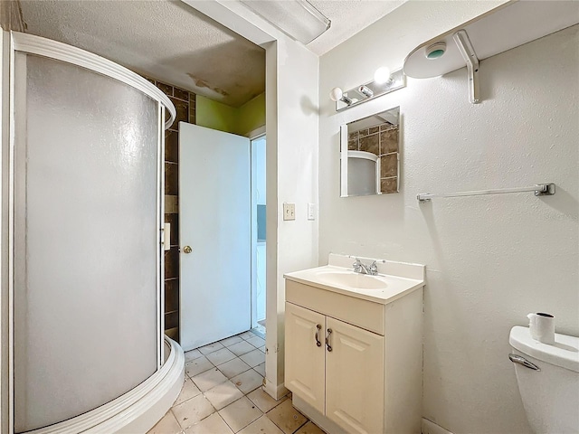 bathroom featuring tile patterned flooring, an enclosed shower, vanity, a textured ceiling, and toilet