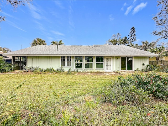 rear view of house with a lawn