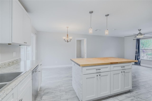 kitchen with butcher block counters, decorative light fixtures, dishwasher, a kitchen island, and white cabinets