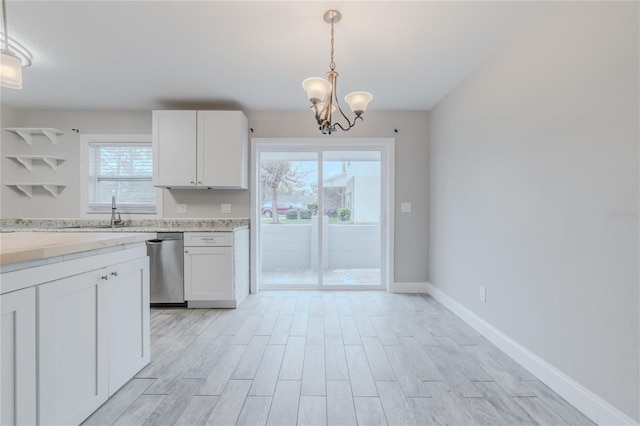 kitchen featuring hanging light fixtures, light hardwood / wood-style floors, and white cabinets