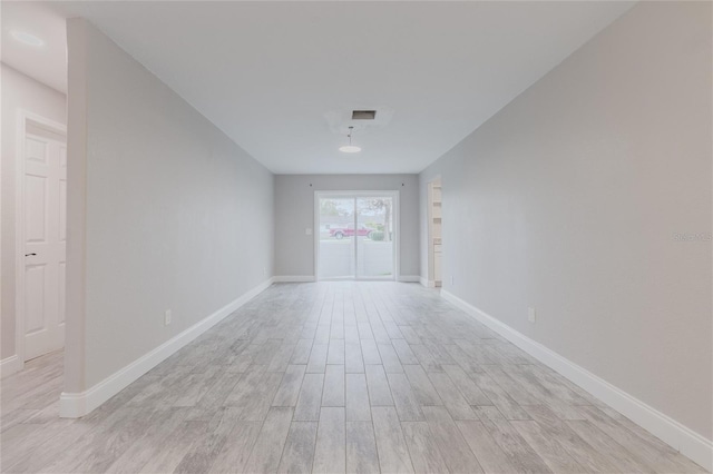 unfurnished room with light wood-type flooring