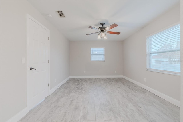 empty room with light hardwood / wood-style floors and ceiling fan