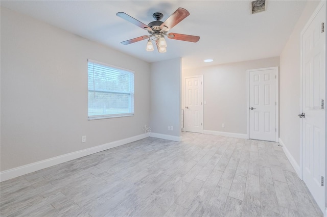 spare room featuring ceiling fan and light wood-type flooring