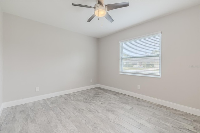 empty room with ceiling fan and light hardwood / wood-style floors