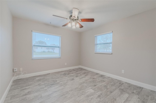 empty room featuring ceiling fan and light hardwood / wood-style floors