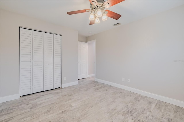 unfurnished bedroom with a closet, ceiling fan, and light wood-type flooring