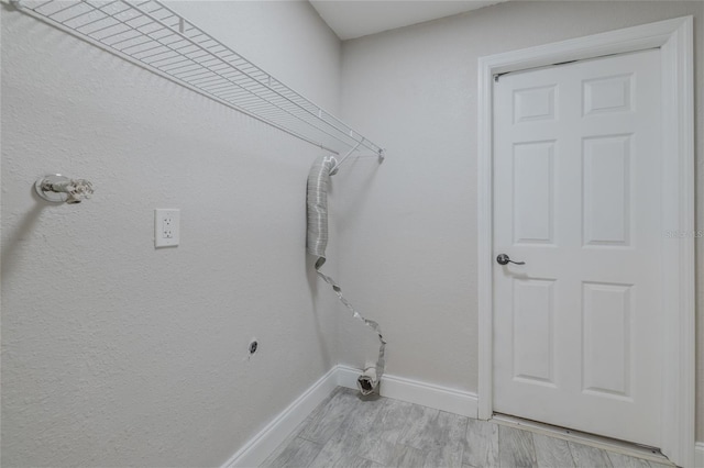 clothes washing area featuring light wood-type flooring