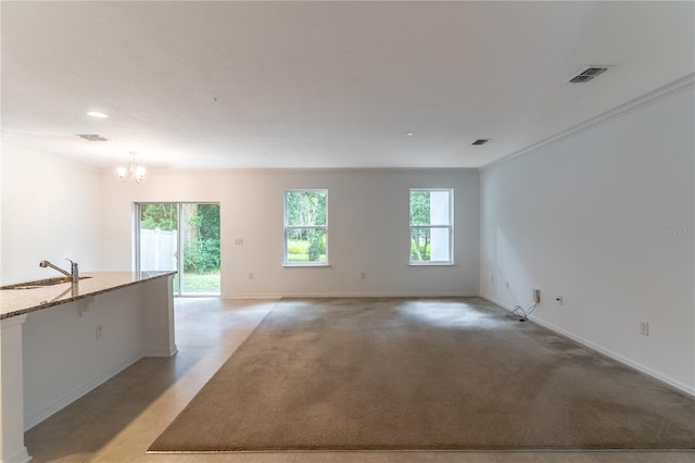 unfurnished room with an inviting chandelier, sink, and ornamental molding