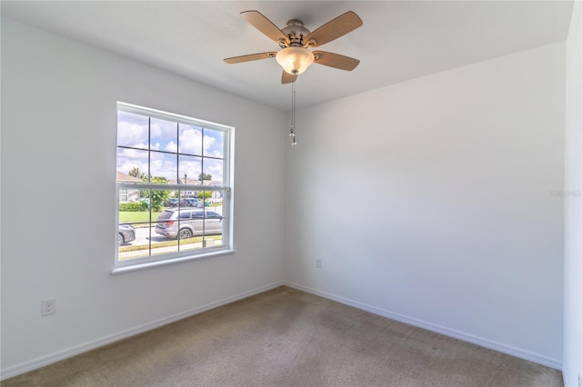 unfurnished room featuring light carpet and ceiling fan