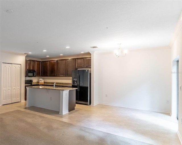 kitchen with sink, a breakfast bar area, crown molding, a center island with sink, and black appliances