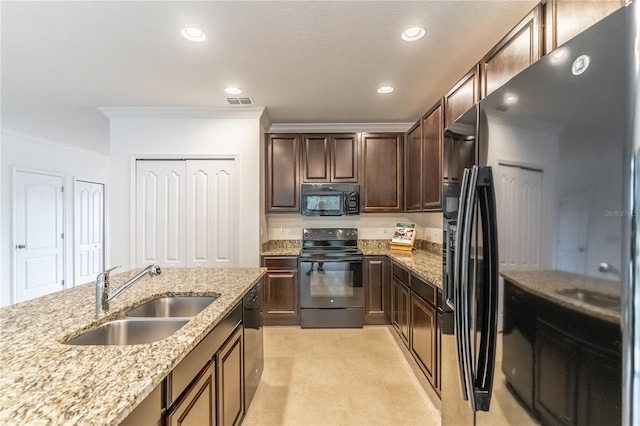 kitchen featuring light stone counters, sink, ornamental molding, and black appliances