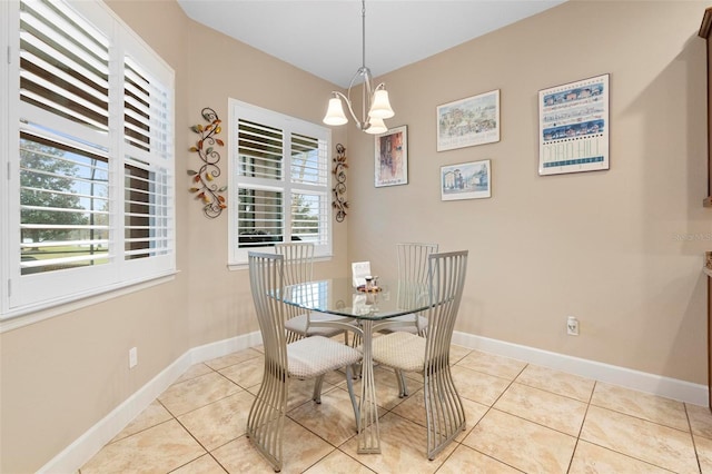 dining area featuring light tile patterned floors and a notable chandelier