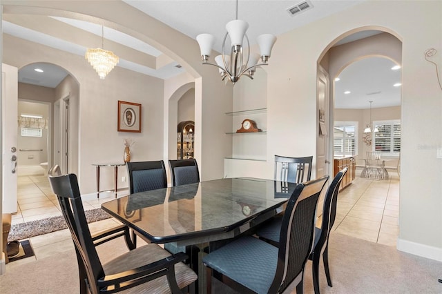 dining area with a notable chandelier and light tile patterned flooring