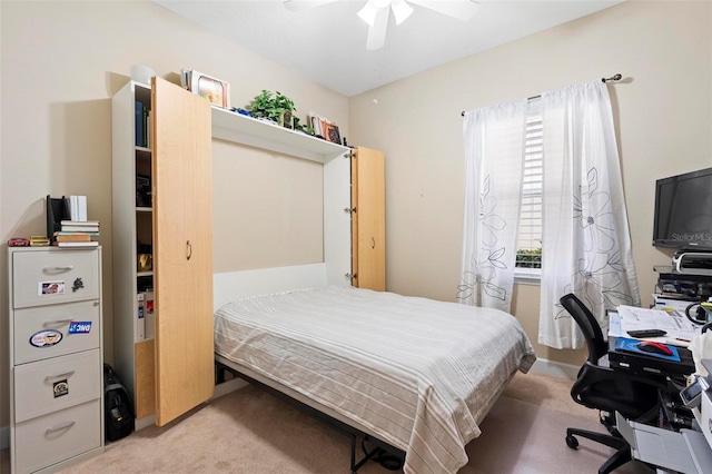 bedroom featuring light colored carpet and ceiling fan