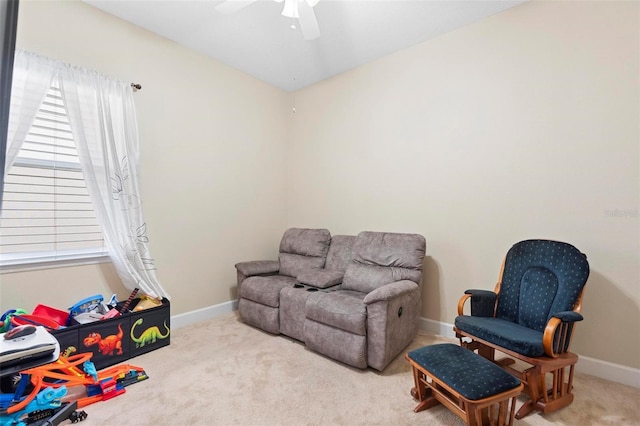 interior space featuring light carpet and ceiling fan