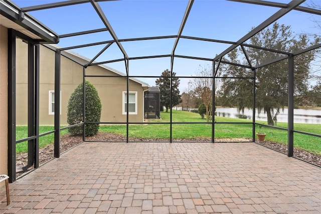 unfurnished sunroom featuring a water view